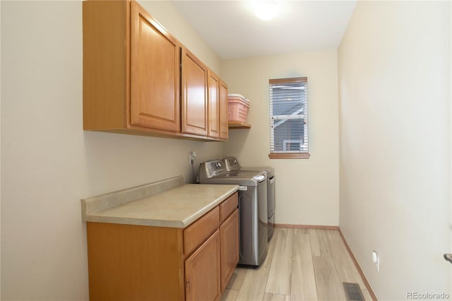 12754 Angelina Dr, Peyton, CO 80831 - laundry room featuring cabinet space, washing machine and dryer, and light wood-style flooring
