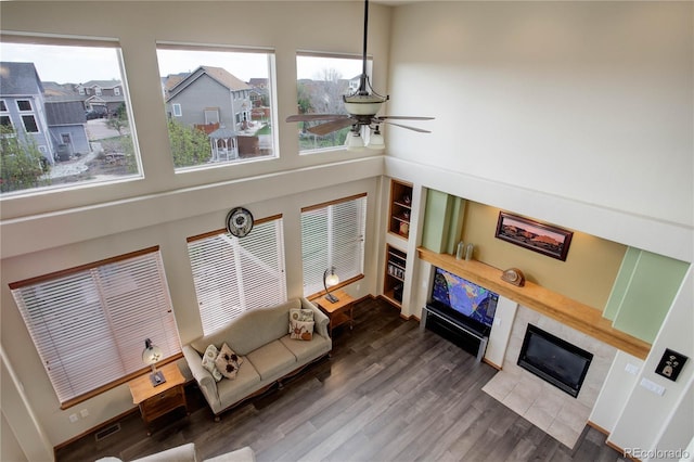 12754 Angelina Dr, Peyton, CO 80831 - living room featuring a fireplace, ceiling fan, and wood finished floors