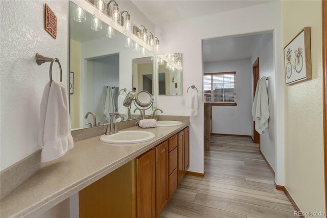 12754 Angelina Dr, Peyton, CO 80831 - bathroom with double vanity and wood finished floors