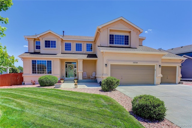 12754 Angelina Dr, Peyton, CO 80831 - view of front of house with stucco siding, driveway, and roof with shingles