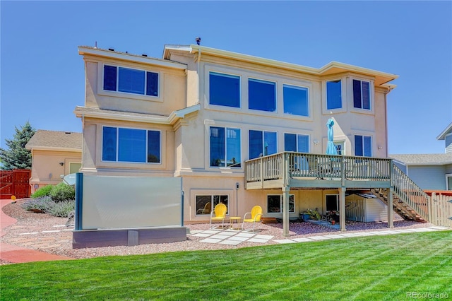 12754 Angelina Dr, Peyton, CO 80831 - back of property with a wooden deck, stairs, and stucco siding