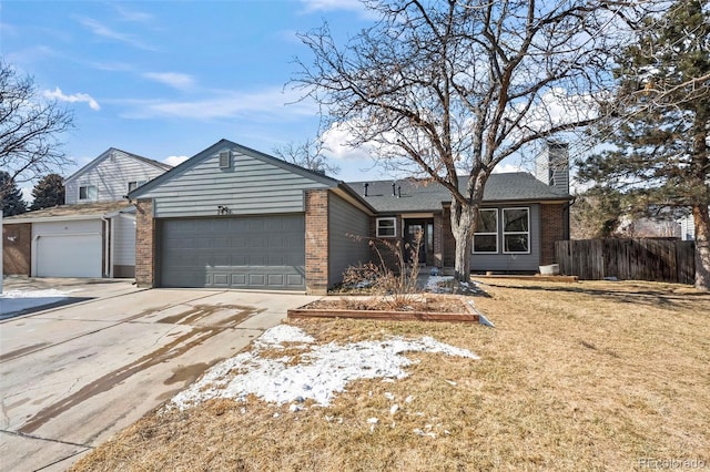 ranch-style home featuring a garage, brick siding, a chimney, and fence