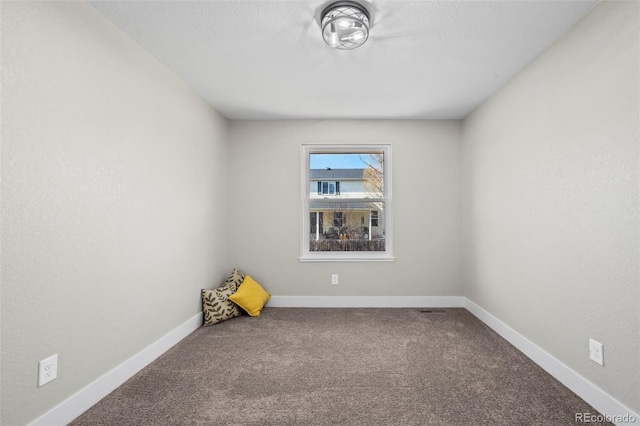 spare room with carpet flooring and baseboards