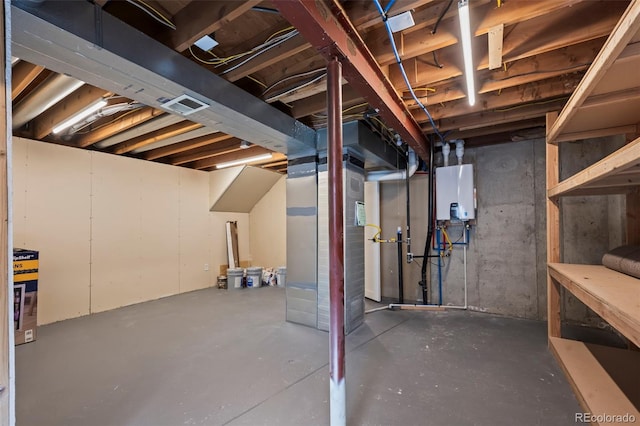 unfinished basement featuring water heater