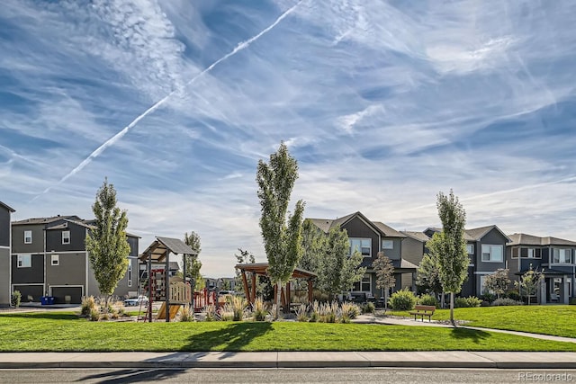 exterior space with playground community, a residential view, and a lawn