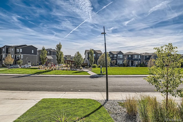 view of road with sidewalks, a residential view, and curbs