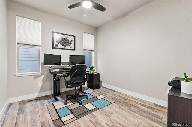 office featuring a ceiling fan, baseboards, and wood finished floors