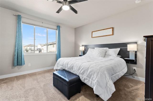 bedroom with ceiling fan, baseboards, and carpet