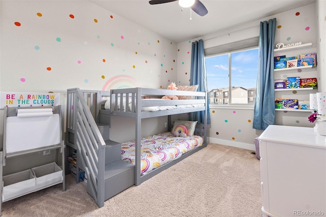 carpeted bedroom featuring baseboards and ceiling fan