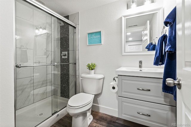 full bath featuring visible vents, a shower stall, toilet, wood finished floors, and vanity