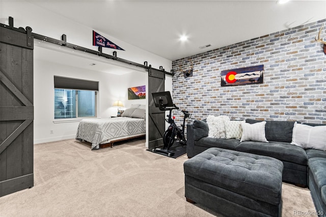 bedroom with a barn door, carpet floors, brick wall, baseboards, and an accent wall
