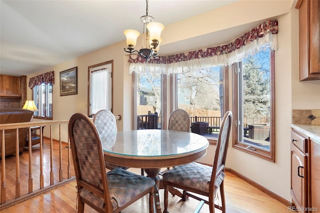 dining area featuring a notable chandelier and light hardwood / wood-style flooring