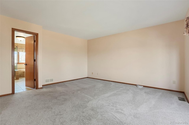 empty room featuring light colored carpet