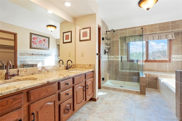 bathroom with vanity, lofted ceiling, and shower with separate bathtub