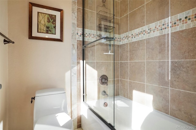 bathroom featuring shower / bath combination with glass door and toilet