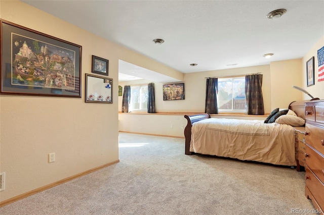 bedroom featuring light colored carpet