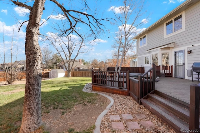 view of yard with a storage unit and a deck