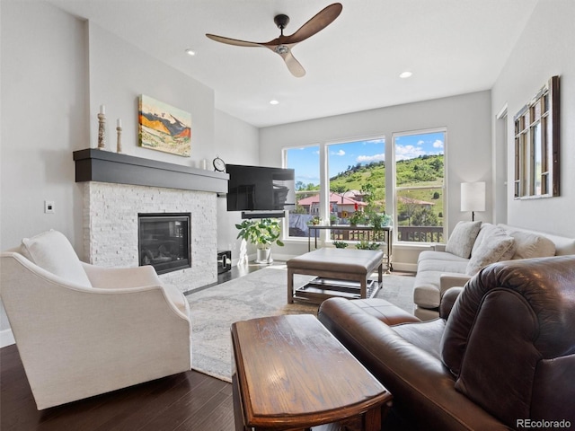 6268 Dakota Ridge Dr, Littleton, CO 80125 - living room with dark wood-style floors, ceiling fan, a stone fireplace, recessed lighting, and baseboards