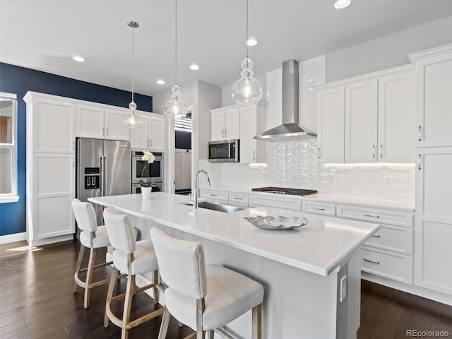 6268 Dakota Ridge Dr, Littleton, CO 80125 - kitchen featuring stainless steel appliances, wall chimney range hood, a sink, dark wood-style floors, and tasteful backsplash