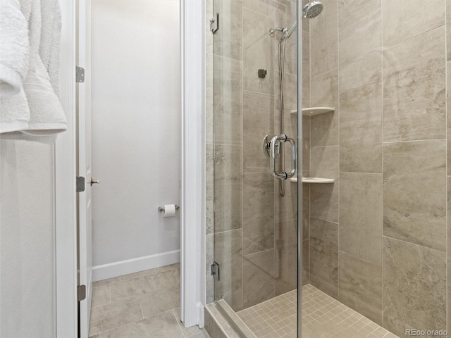 6268 Dakota Ridge Dr, Littleton, CO 80125 - bathroom with a stall shower, baseboards, and tile patterned floors