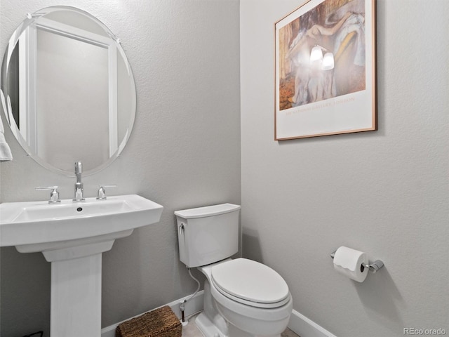 6268 Dakota Ridge Dr, Littleton, CO 80125 - half bath with toilet, baseboards, and a sink