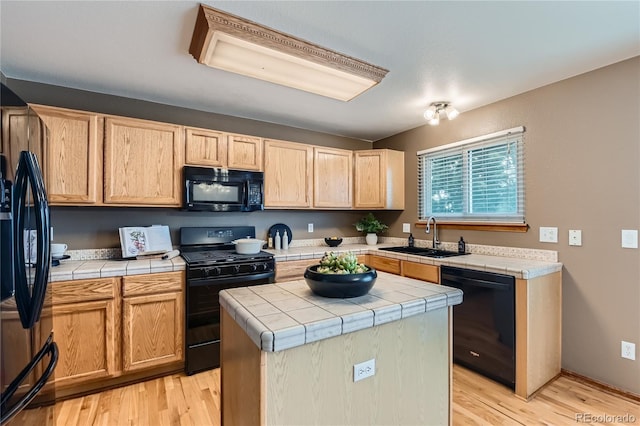 11363 Latigo Ln, Parker, CO 80138 - kitchen with black appliances, tile counters, and light wood-style flooring