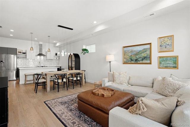 1250 W Osceola St Unit 2, Denver, CO 80204 - living room with light wood-style flooring, recessed lighting, and arched walkways