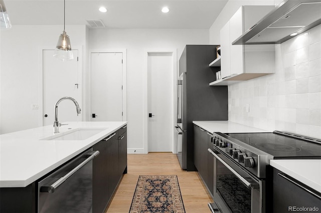 1250 W Osceola St Unit 2, Denver, CO 80204 - kitchen featuring appliances with stainless steel finishes, wall chimney exhaust hood, open shelves, light countertops, and recessed lighting