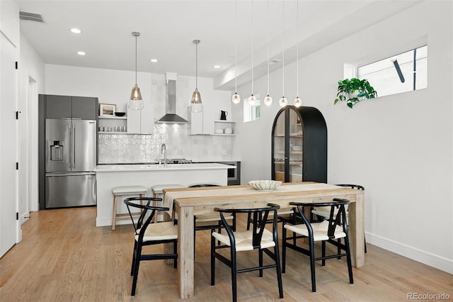 1250 W Osceola St Unit 2, Denver, CO 80204 - dining space with light wood-style flooring and recessed lighting