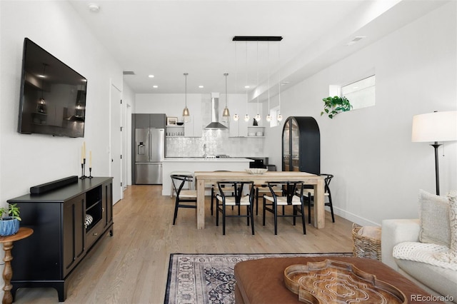 1250 W Osceola St Unit 2, Denver, CO 80204 - living room featuring light wood-style floors, recessed lighting, and arched walkways