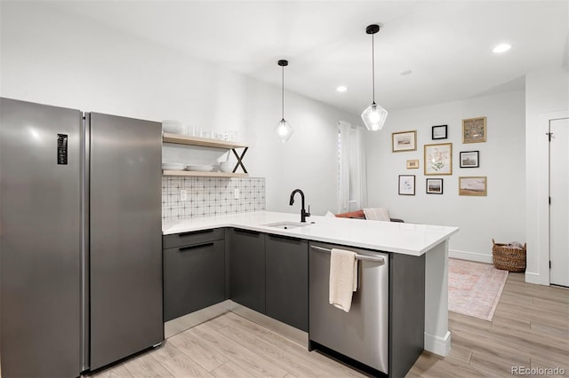 1250 W Osceola St Unit 2, Denver, CO 80204 - kitchen featuring appliances with stainless steel finishes, a peninsula, light countertops, open shelves, and recessed lighting