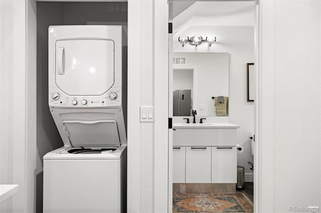 1250 W Osceola St Unit 2, Denver, CO 80204 - washroom with stacked washer and clothes dryer and a sink