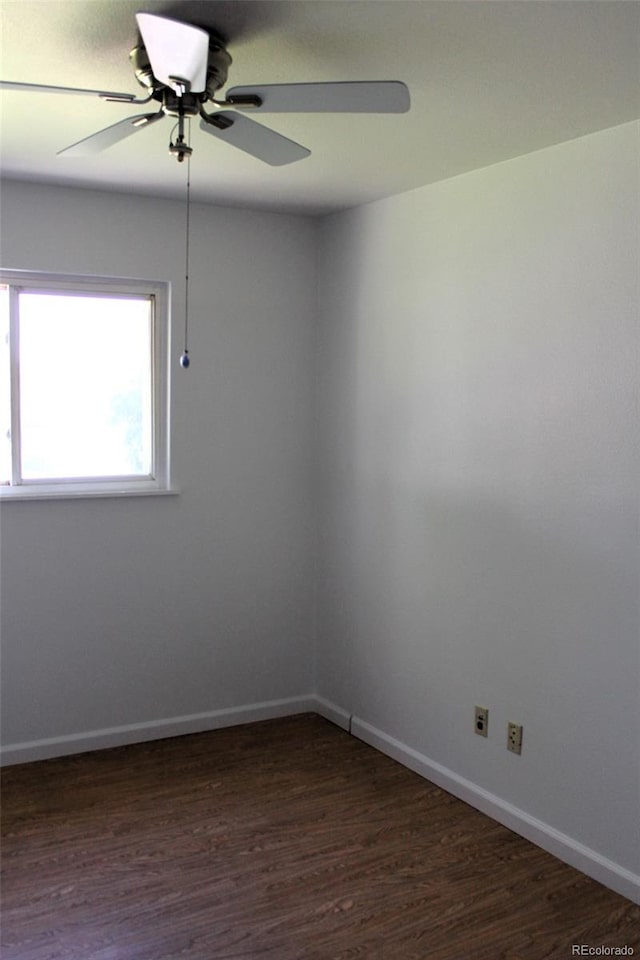 unfurnished room with ceiling fan and dark wood-type flooring