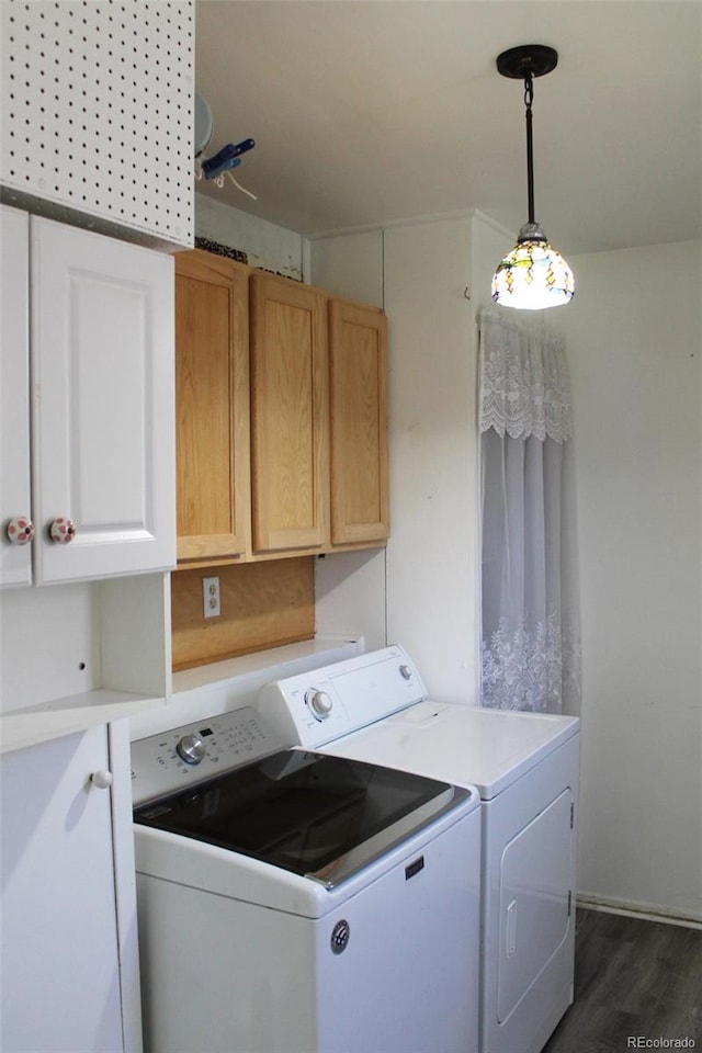 washroom featuring cabinets, dark wood-type flooring, and washer and dryer