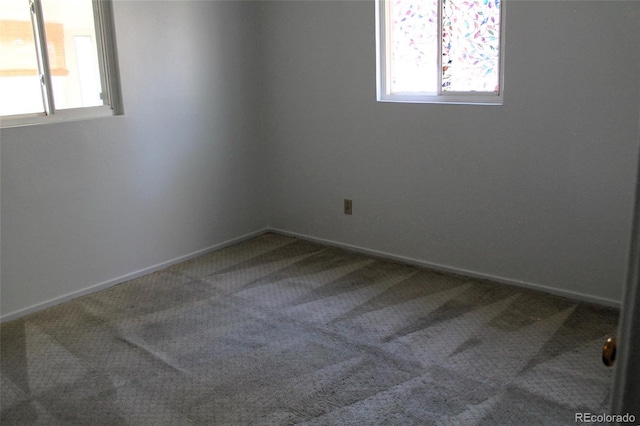 carpeted empty room with a wealth of natural light