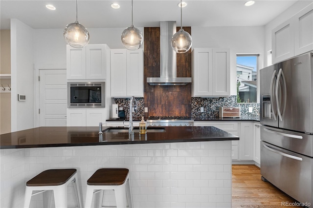 5046 Uinta St, Denver, CO 80238 - kitchen with stainless steel fridge with ice dispenser, built in microwave, wall chimney range hood, dark countertops, and tasteful backsplash