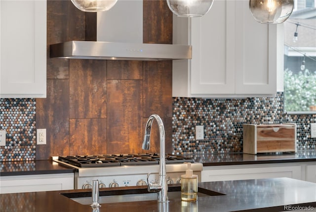 5046 Uinta St, Denver, CO 80238 - kitchen featuring wall chimney range hood, dark countertops, backsplash, and white cabinetry