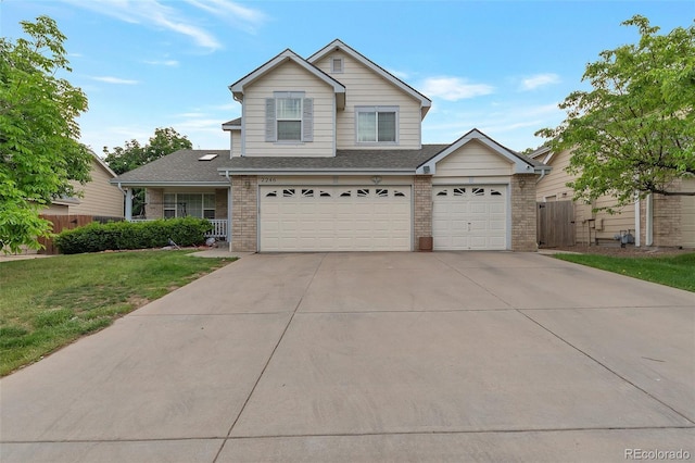 2246 S Ensenada St, Aurora, CO 80013 - traditional home with brick siding, concrete driveway, a shingled roof, and an attached garage