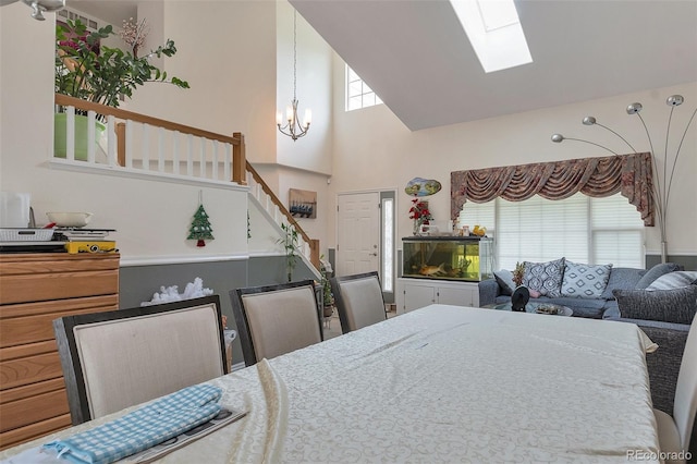 2246 S Ensenada St, Aurora, CO 80013 - dining area featuring stairway, a skylight, a chandelier, and high vaulted ceiling