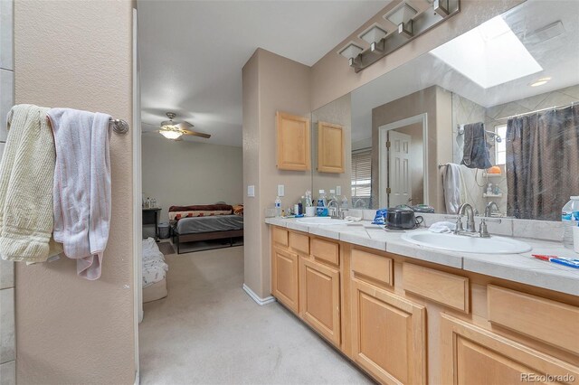 2246 S Ensenada St, Aurora, CO 80013 - ensuite bathroom with double vanity, a skylight, a shower with curtain, and a ceiling fan