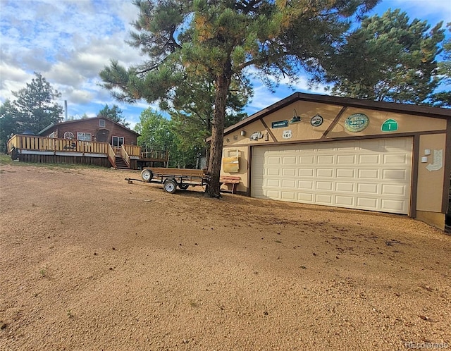 garage featuring dirt driveway