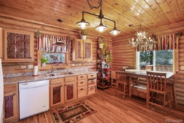 kitchen featuring log walls, dishwasher, and a sink