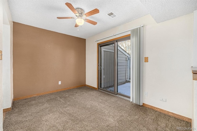 carpeted empty room with a textured ceiling and ceiling fan