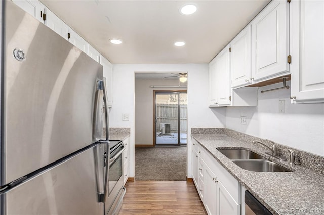 kitchen with light hardwood / wood-style floors, stainless steel appliances, ceiling fan, white cabinets, and sink