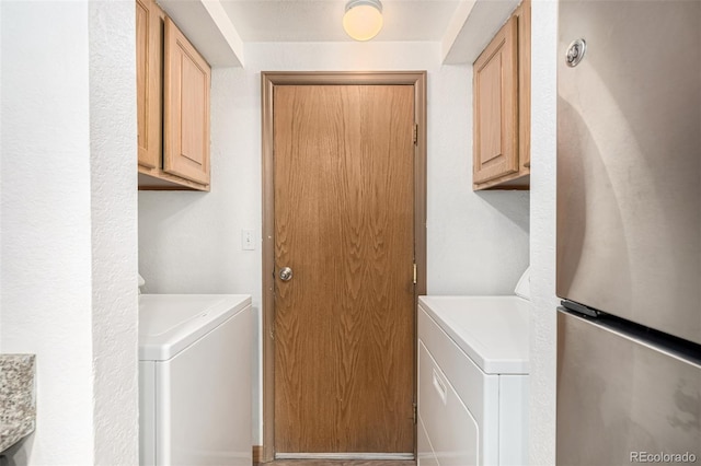 laundry area with washer / dryer and cabinets