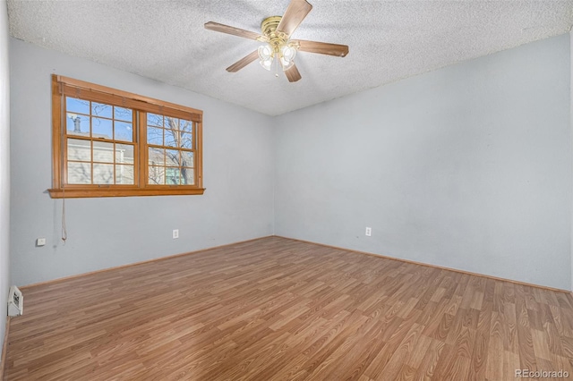 unfurnished room featuring a textured ceiling, ceiling fan, and light hardwood / wood-style flooring