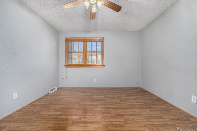 empty room featuring a textured ceiling, ceiling fan, and light hardwood / wood-style floors