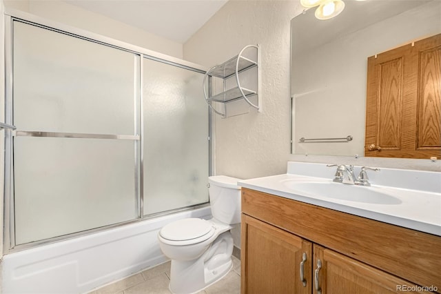 full bathroom featuring vanity, tile patterned flooring, combined bath / shower with glass door, and toilet