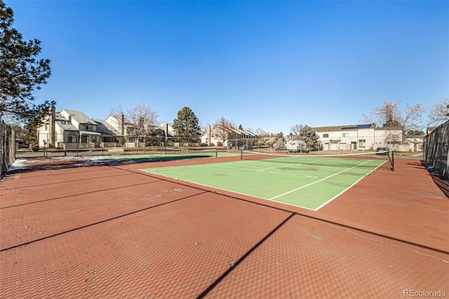 view of tennis court featuring basketball hoop