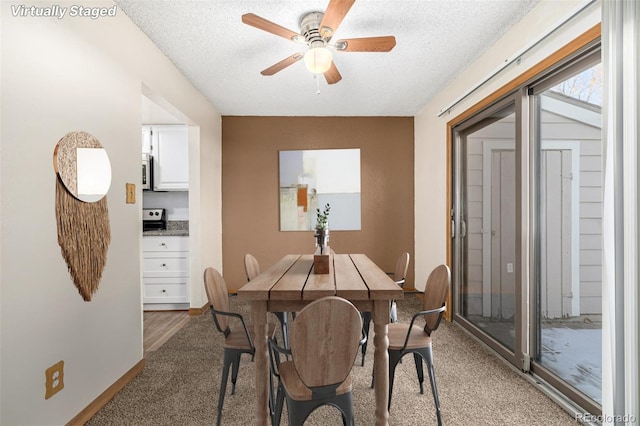 dining area featuring a textured ceiling and ceiling fan